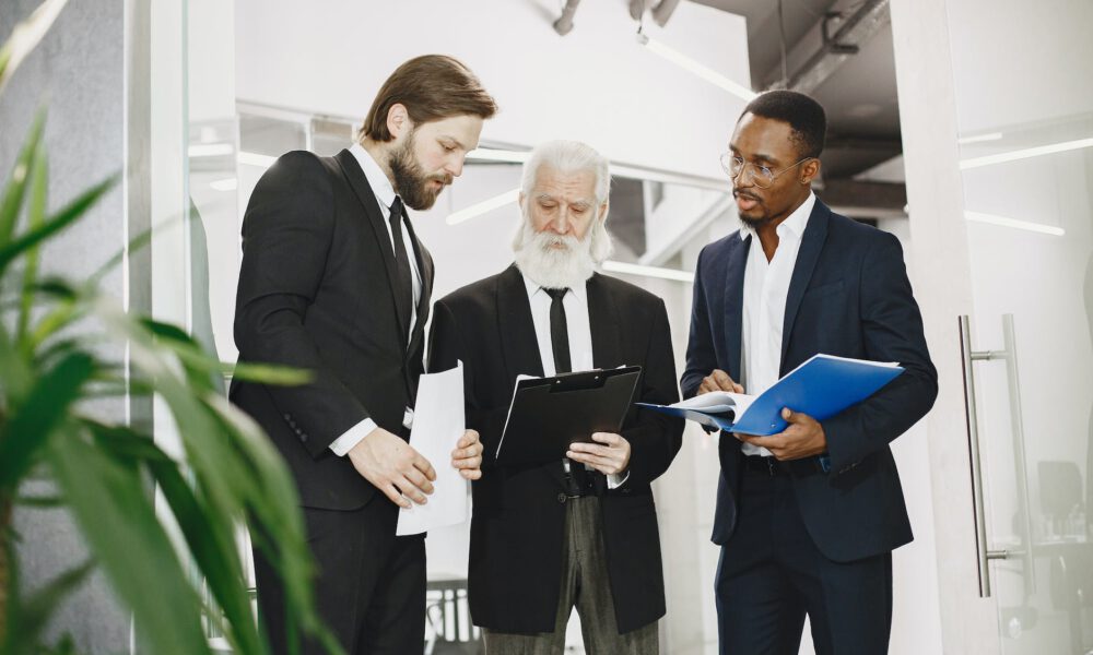 men in office discussing documents